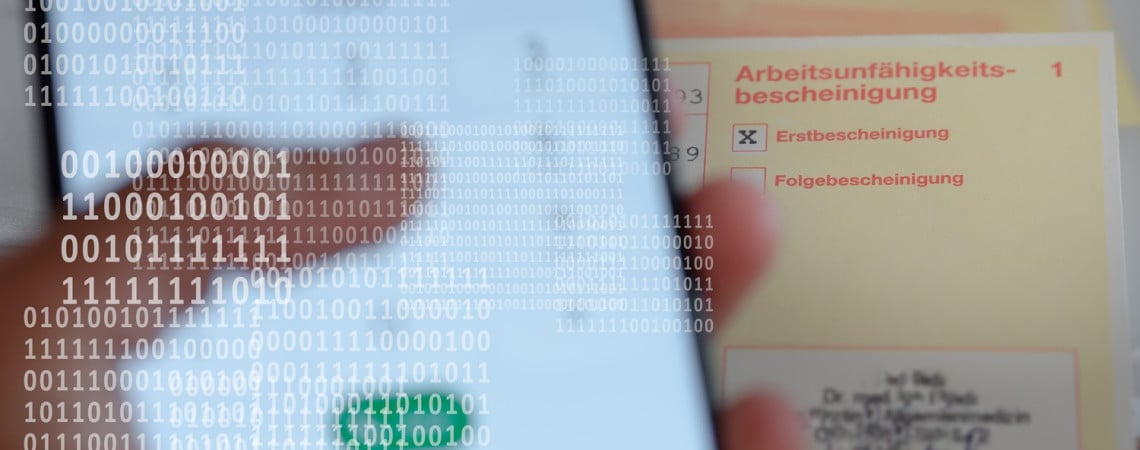 Krankschreibung im Hintergrund und ein Handy 